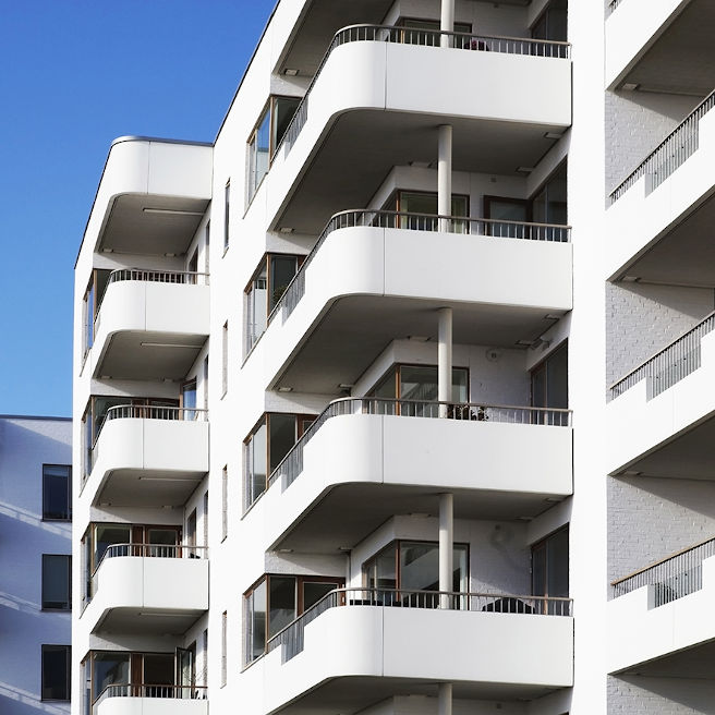 edificio blanco de varias plantas  con balcones exteriores